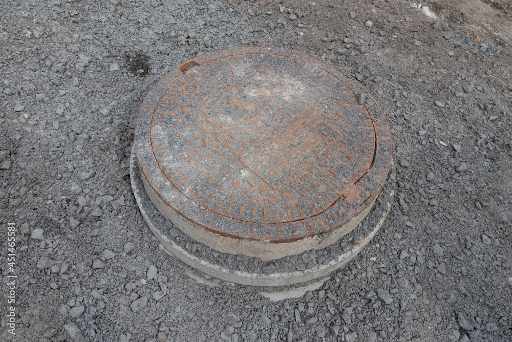 Manhole cover bared up the over ground in construction building asphalt rod reconstruction site