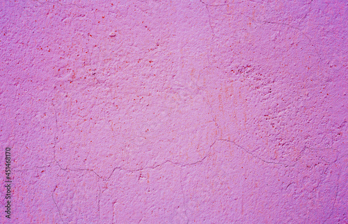 Old peeling paint on the wall. purple abstract background...Background from purple stucco.