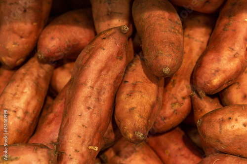 A bunch of sweet potatoes in the store. Vitamins and healthy food. Background.