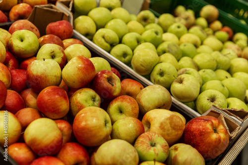 Apples in boxes in the store. Side view. Vitamins and healthy food.