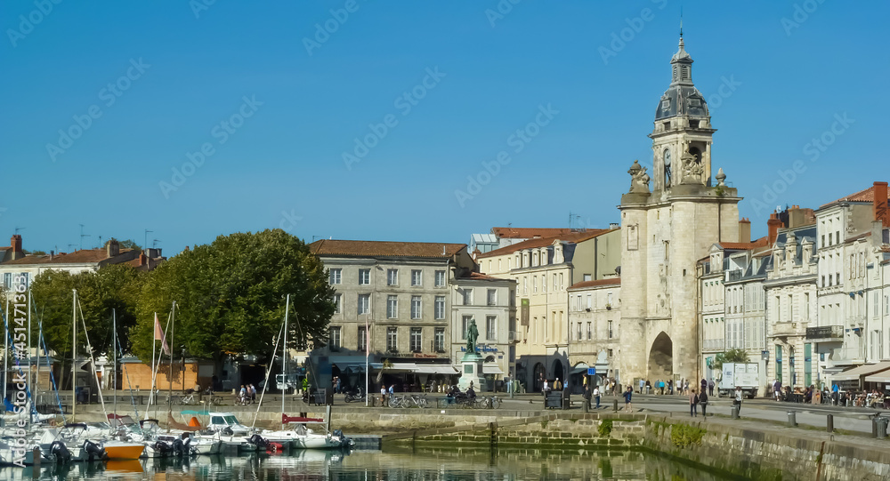La Rochelle, France - September 9. 2016: View on harbor with church tower against blue summer sky