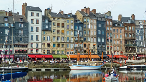 Honfleur, France - October 8. 2015: View on harbor promenade with typical breton old houses and boats