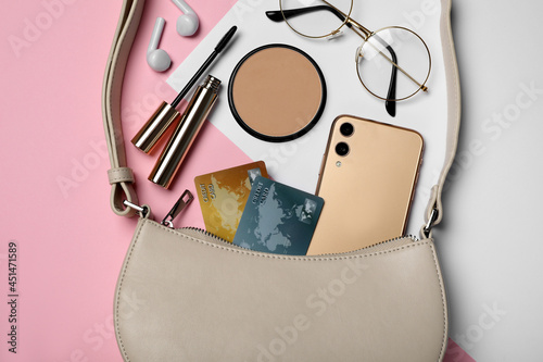 Flat lay composition with stylish woman's bag on color background