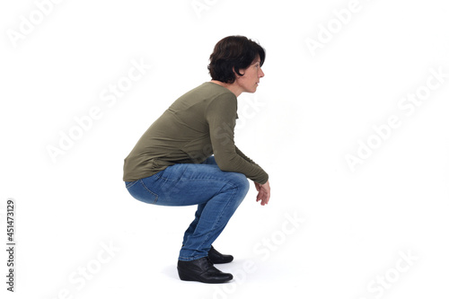 side view of a woman sitting squatting on white background