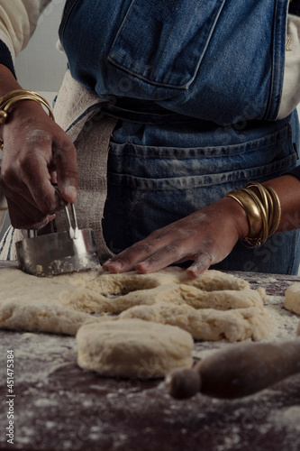 baker cutting biscuits from rolled dough
