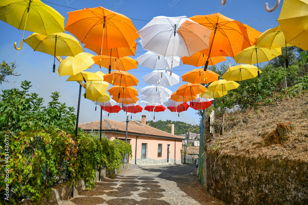 Colorful umbrellas in the cityscape of Acri, a medieval village in the Calabria region of Italy.	