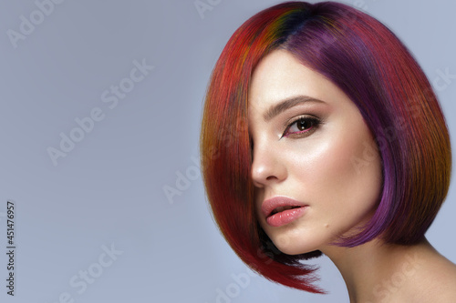 Beautiful woman with multi-colored hair and creative make up and hairstyle. Beauty face.