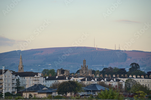 Beautiful morning view of roofs of houses, churches and castles, and Three Rock Mountain with cellular antennas seen from Dun Laoghaire harbor (West Pier), Dublin, Ireland. High resolution. Soft focus © Romio Shots