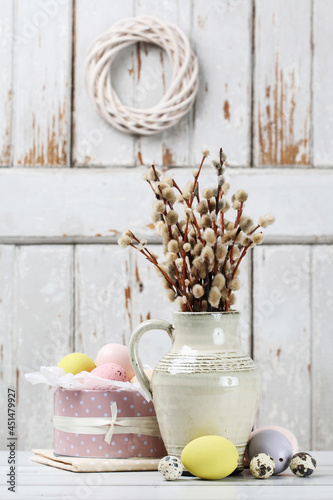 Photos Easter table decoration with bunch of catkins and painted eggs
