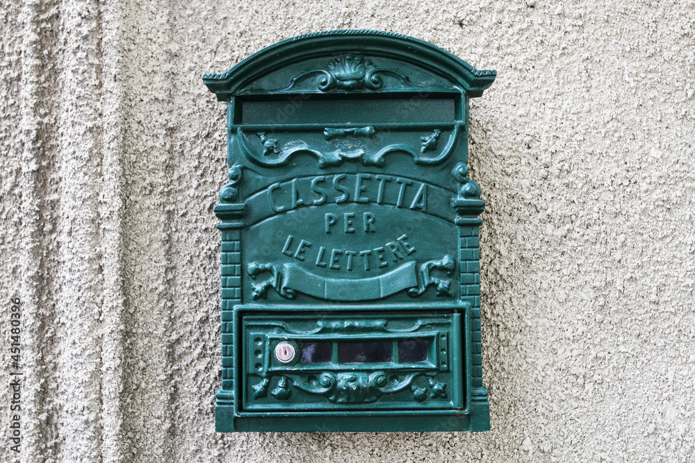 ROME,ITALY - AUGUST 17, 2021: Green italian mailbox on the wall in Rome, Italy.