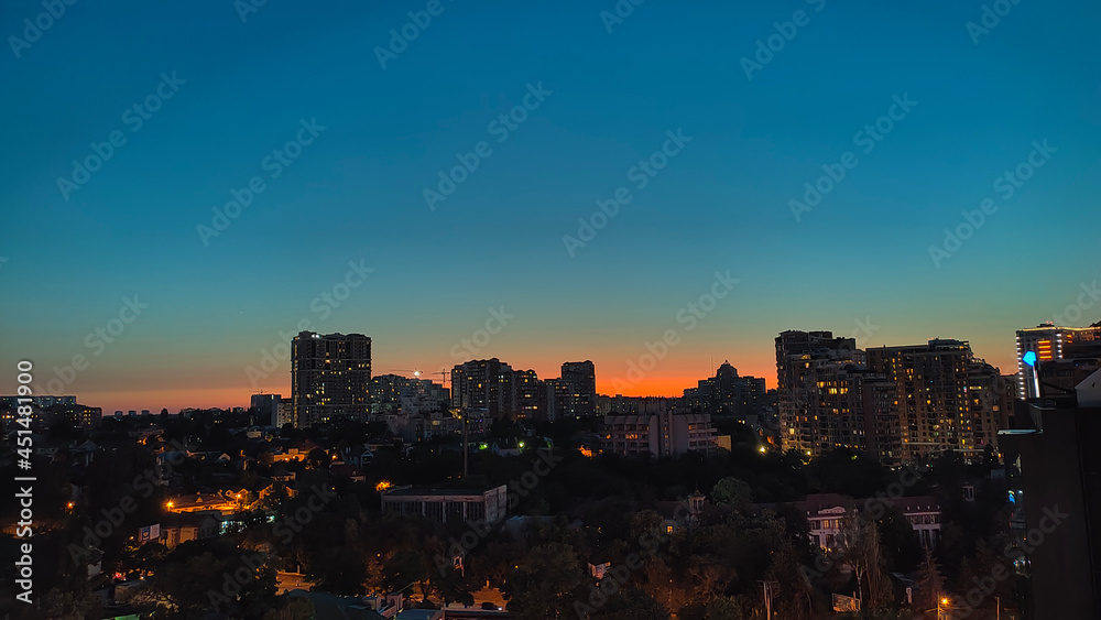 Obraz premium Odessa landscape at sunset. Night city lights. Blue and orange.