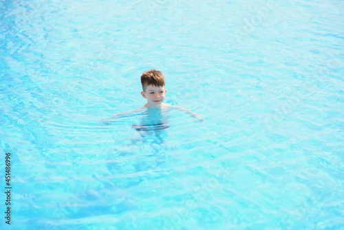 Kid splashing on summer pool