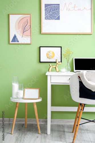 Interior of stylish room with modern workplace and pictures © Pixel-Shot