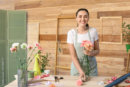 Female florist making bouqu...