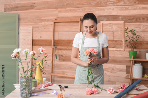 Female florist making bouqu...