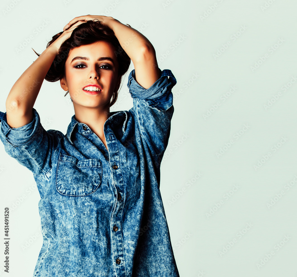 young pretty teenage hipster girl posing emotional happy smiling on white background, lifestyle people concept