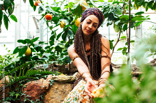 Young cute smiling woman in park with oranges, lifestyle concept green spring photo