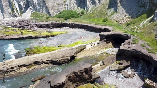 Aerial flight with drone over the Basque coast. Rocky cove between ravines