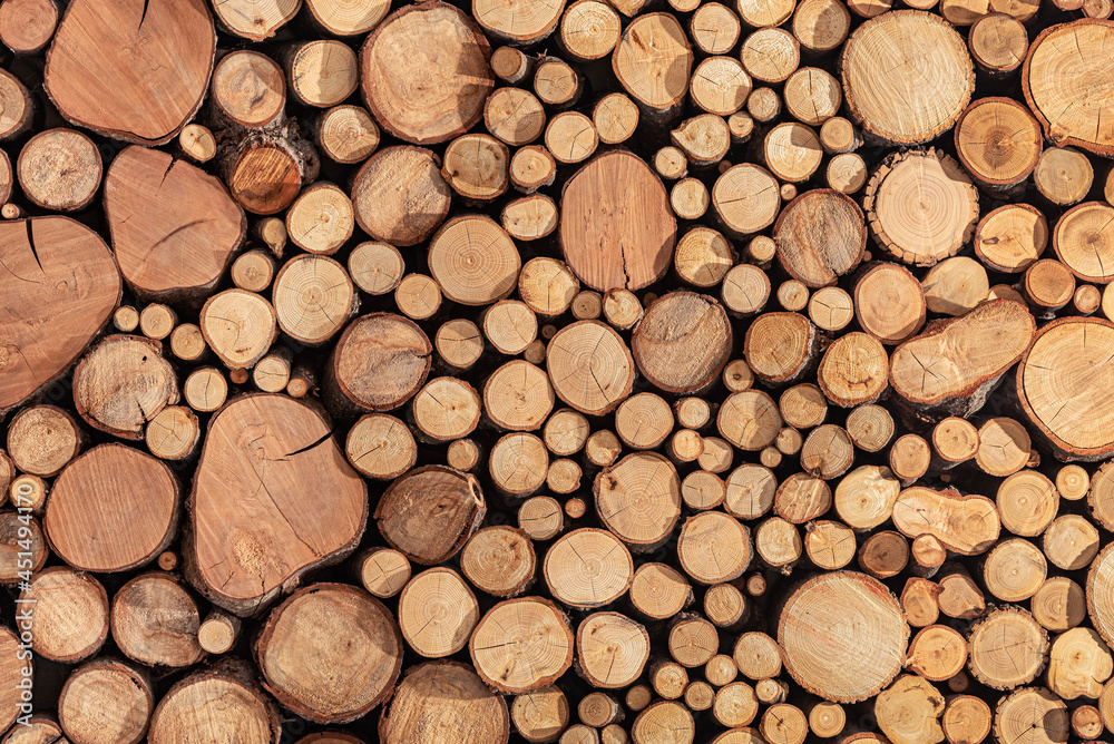 Pile stacked of natural sawn wooden logs background Pile stacked of natural sawn wooden logs background