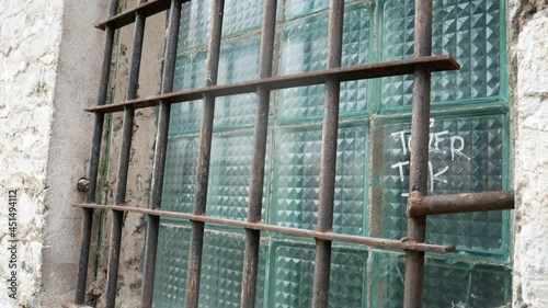 Close-up shot of iron bars in front of a prison window. Exterior view of the abandoned Patarei prison (Patarei Vangla). photo