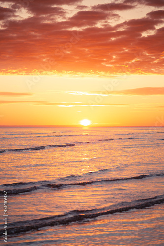 Sunrise over the horizon over the sea at the beach in Darwin, Northern Territory, Australia © Julia