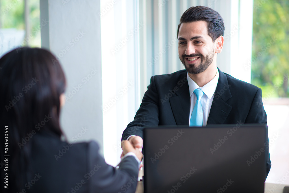 Business man shake hands with business women agreeing on partnerships or introducing themselves for first time meet Business man shake hands with business women agreeing on partnerships or introducing themselves for first time meet
