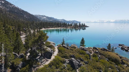 Aerial shot reveals pristine bay and snow-capped peaks at Lake Tahoe