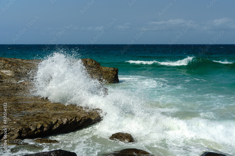 Surf wave crashing on rock that looks like a sleeping dog, at Coolangatta, Queensland, Australia. Surf wave crashing on rock that looks like a sleeping dog, at Coolangatta, Queensland, Australia.