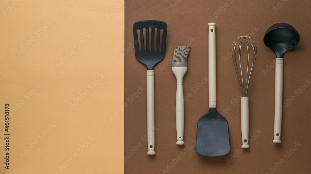 Plastic kitchen utensils for cooking on a two-color background. Flat lay. Plastic kitchen utensils for cooking on a two-color background. Flat lay.