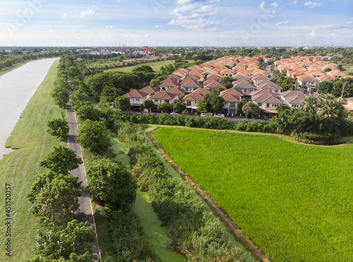 Land or landscape of green field in aerial view. Include agriculture farm, house building, village. That real estate or property. Plot of land for housing subdivision, development, sale or investment. photo