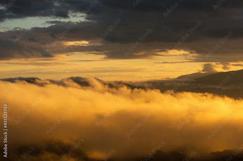 Fototapeta premium Aerial view Beautiful of morning scenery Golden light sunrise And the mist flows on high mountains, Wonder fog.