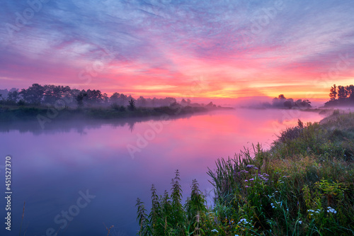 Colorful sunrise over the river banks