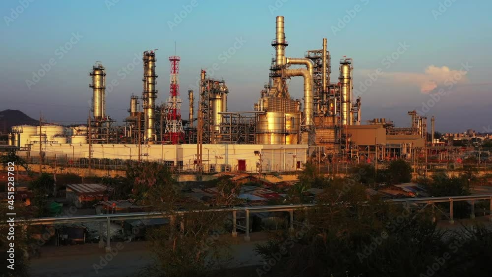 Oil refinery plant from industry zone, Aerial view oil and gas petrochemical industrial, Refinery factory oil storage tank and pipeline steel at twilight. Oil refinery plant from industry zone, Aerial view oil and gas petrochemical industrial, Refinery factory oil storage tank and pipeline steel at twilight.