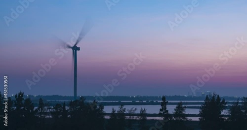 At sunset, China's rural coastal energy wind turbine time-lapse photography