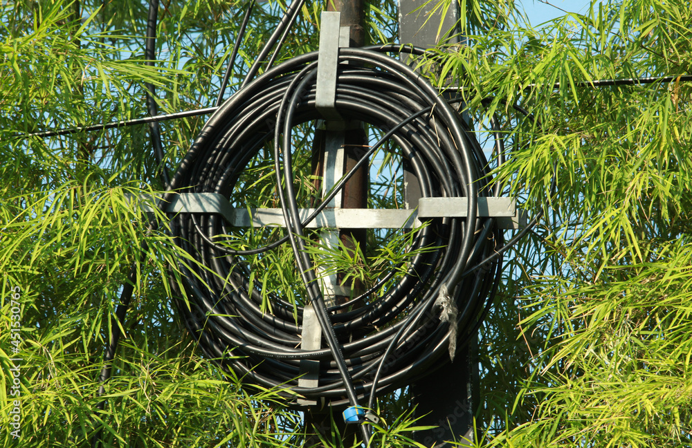 Fiber optic cable reel hanging on iron pole Stock Photo | Adobe Stock