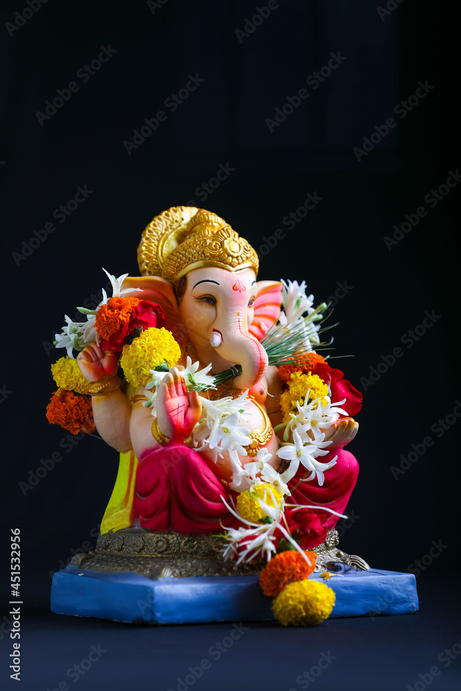 Fototapeta premium Decorative Lord ganesha sclupture on dark background.