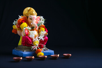 Decorative Lord ganesha sclupture on dark background.