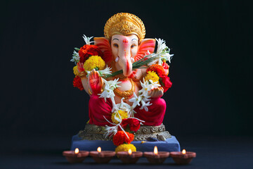 Decorative Lord ganesha sclupture on dark background.