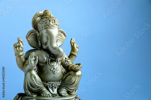 lord ganesha sclupture over blue background. celebrate lord ganesha festival. © Niks Ads