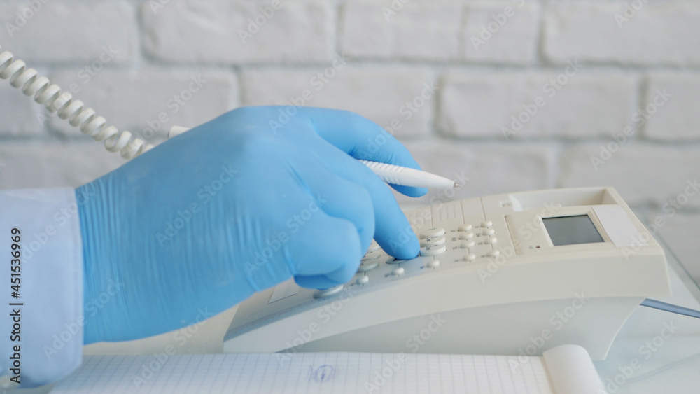 Image with Businessman Hands Wearing Protective Gloves Using Telephone
