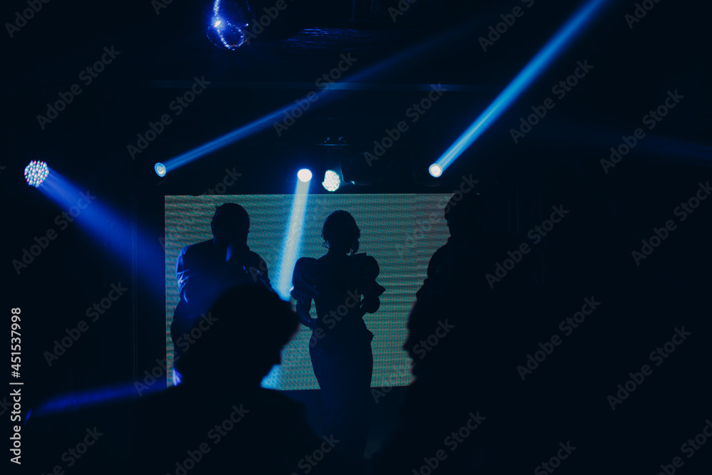 Silhouettes of a crowd on show in night club celebration.