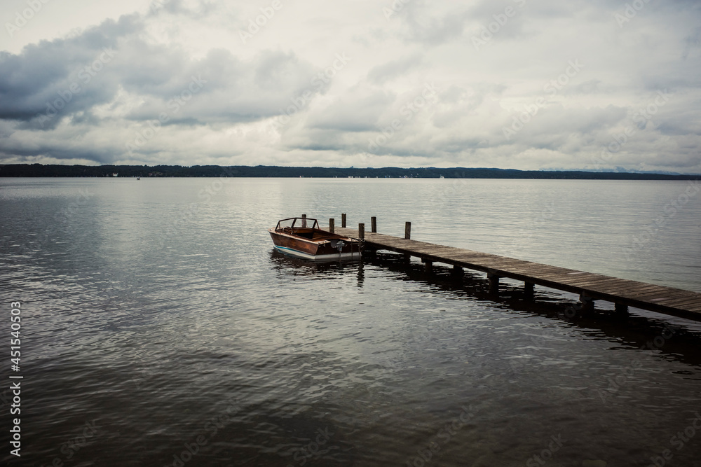 motorboat and wooden pier on the lake
