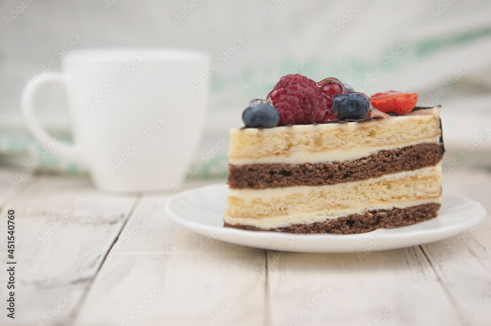 Mix berry cheese cake on white plate on wood background Mix berry cheese cake on white plate on wood background