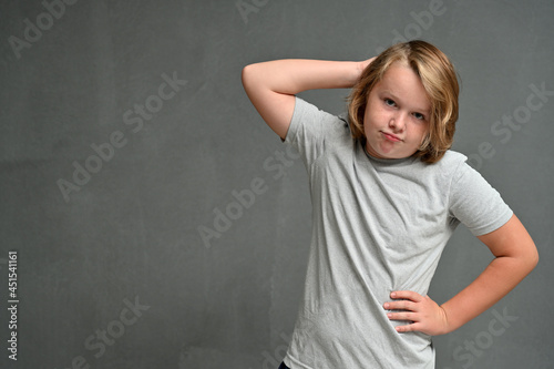high resolution picture guy teenager thinking on a red background in the studio