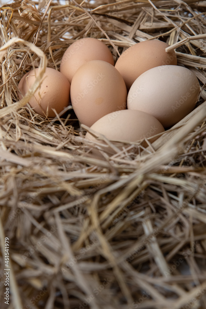 easter basket with easter eggs on straw background easter basket with easter eggs on straw background