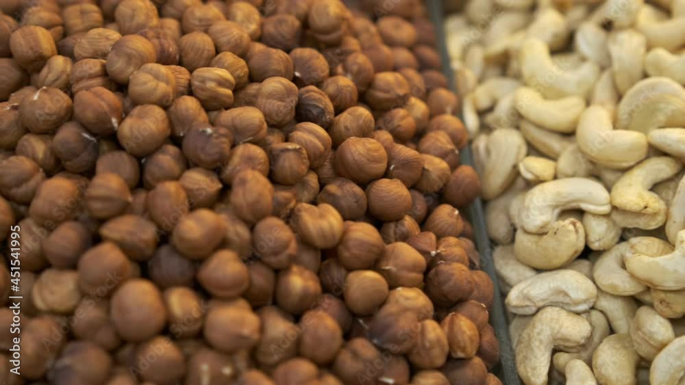 Large Counter of Dried Fruits and Nuts at a Farmers Market . Nuts, dry fruits on display at the market on the showcase. Stall with Various dried fruits Large Counter of Dried Fruits and Nuts at a Farmers Market . Nuts, dry fruits on display at the market on the showcase. Stall with Various dried fruits