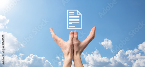 Male hand holding a document icon on blue background. Document Management Data System Business Internet Technology Concept. Corporate data management system DMS