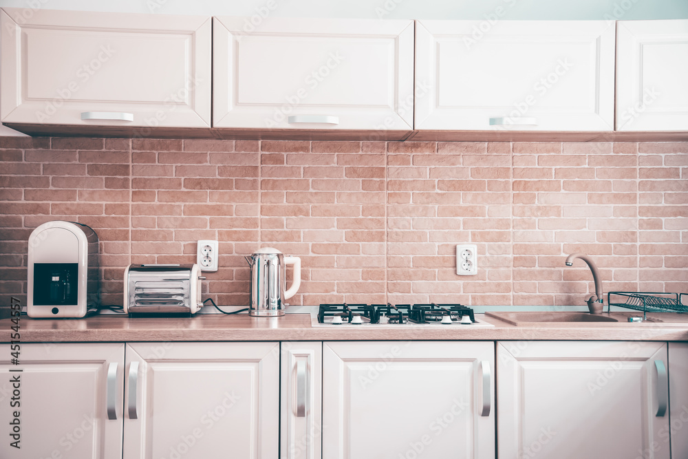 Cozy bright kitchen interior with wooden furniture Cozy bright kitchen interior with wooden furniture