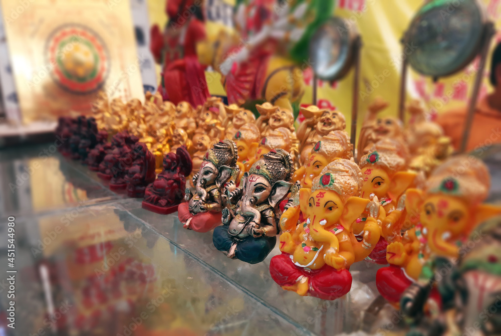 tiny lord ganesha idols on shop for selling selective focus