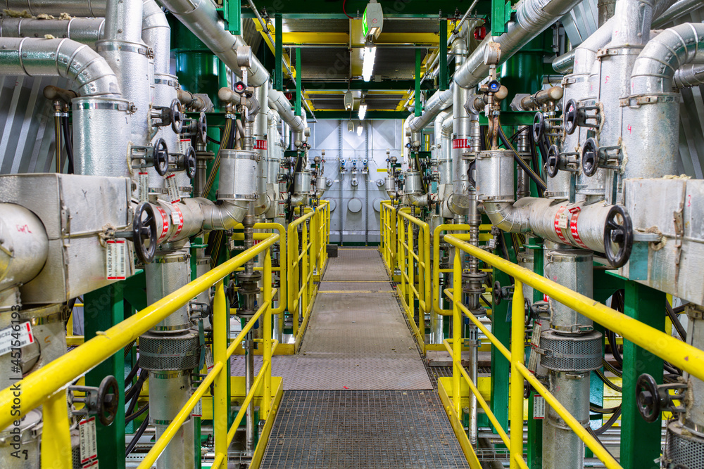 Set of valves and pipes. Factory interior.